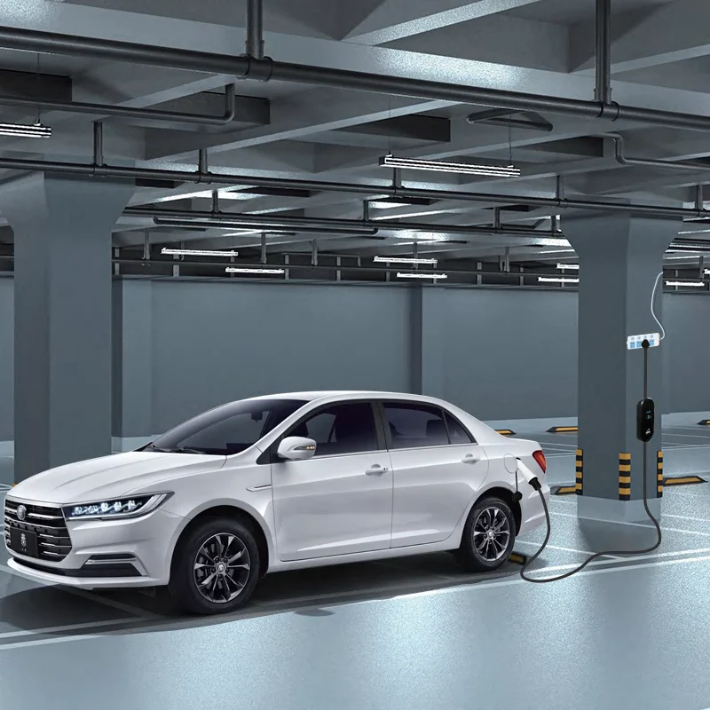 White electric car charging in a parking garage