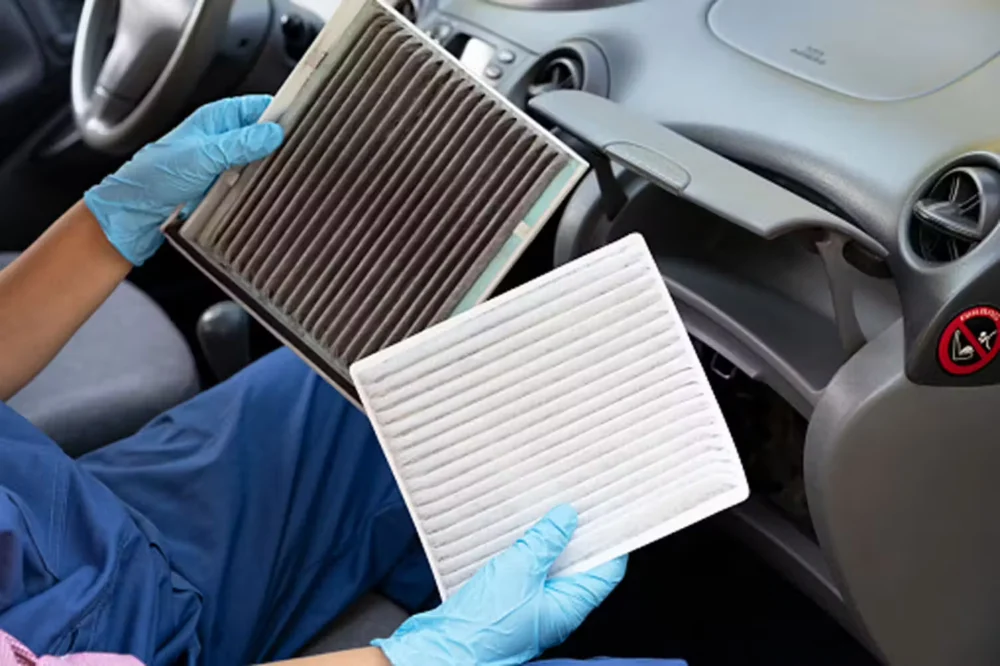 Technician holding a cabin air filter